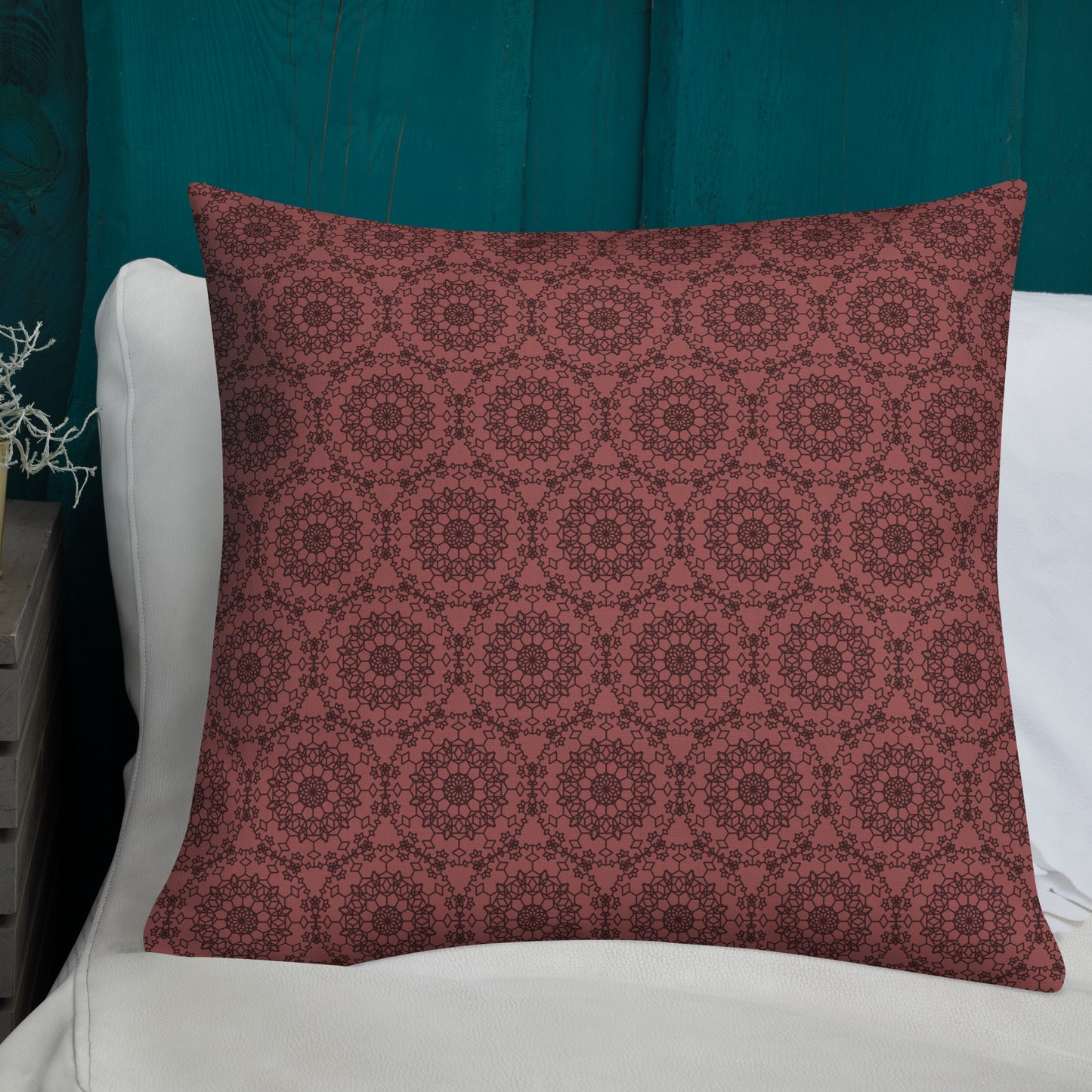 22″×22″ premium throw pillow with the 'Dodecagon' rose geometric pattern on white sofa with teal wooden wall.