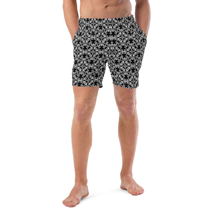 Front shot of a model wearing the swim trunks with the 'Tetragon' black and white fractal geometric pattern.