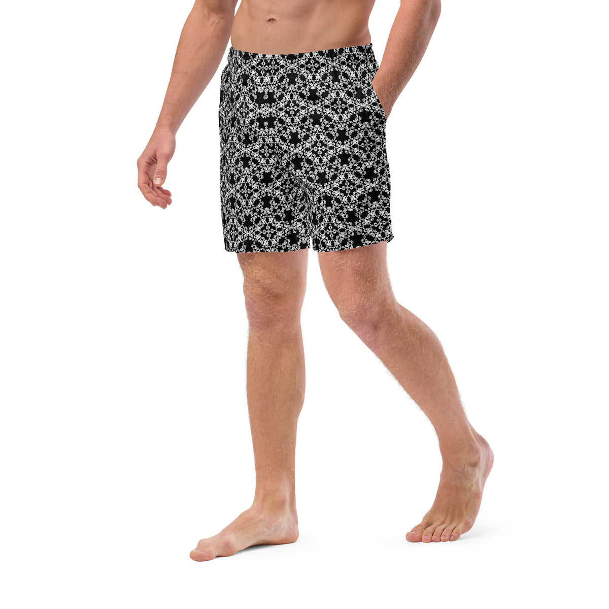Left angle shot of a model wearing the swim trunks with the 'Tetragon' black and white fractal geometric pattern.