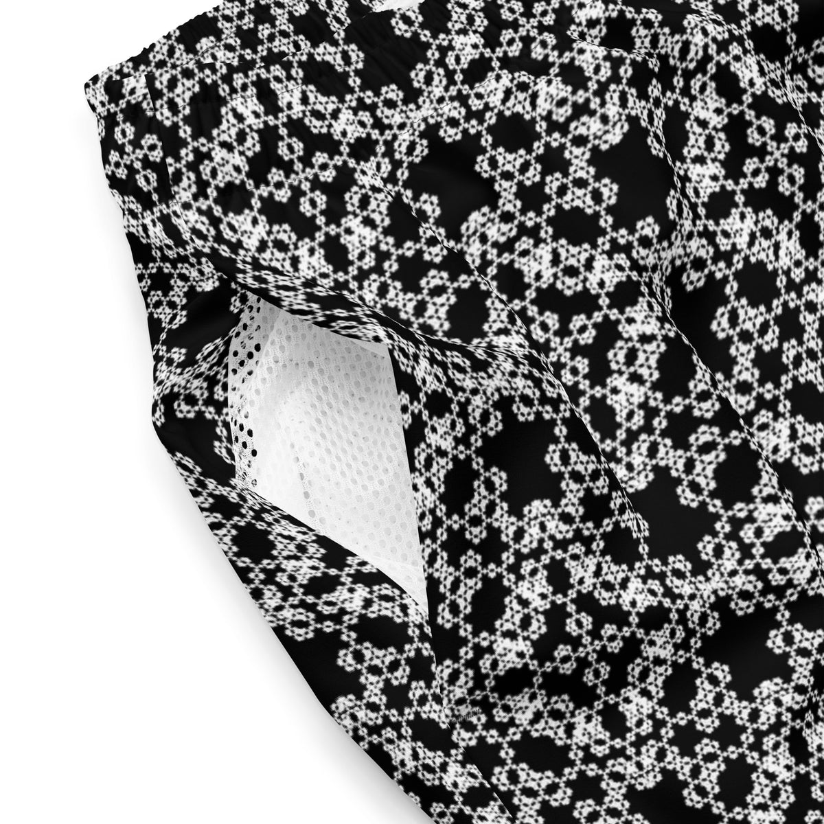 Close shot of the swim trunks with the 'Tetragon' black and white fractal geometric pattern showing the mesh fabric.