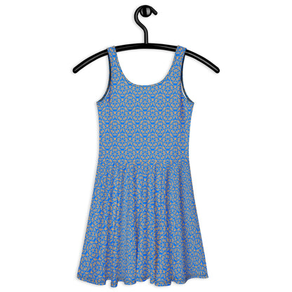 Back of the hung skater dress with the 'Pentagon' blue and yellow fractal geometric pattern.
