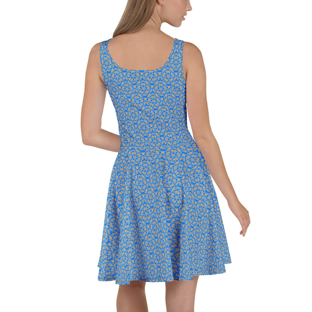 Left angle shot of a model wearing the skater dress with the 'Pentagon' blue and yellow fractal geometric pattern.