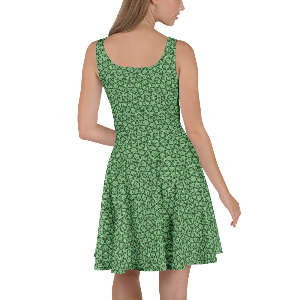 Left angle shot of a model wearing the skater dress with the 'Heptagon' green fractal geometric pattern.