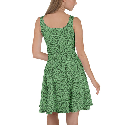 Left angle shot of a model wearing the skater dress with the 'Heptagon' green fractal geometric pattern.