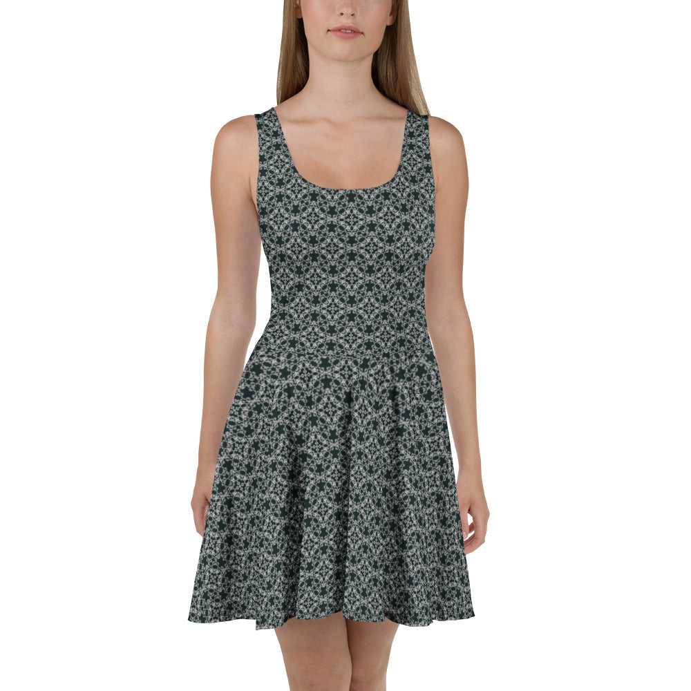 Front shot of a model wearing the skater dress with the 'Quadragon' charcoal and white fractal geometric pattern.