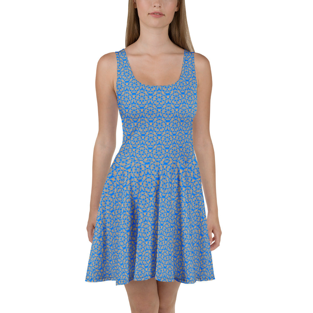 Front shot of a model wearing the skater dress with the 'Pentagon' blue and yellow fractal geometric pattern.