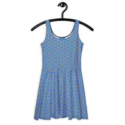 Front of the hung skater dress with the 'Pentagon' blue and yellow fractal geometric pattern.