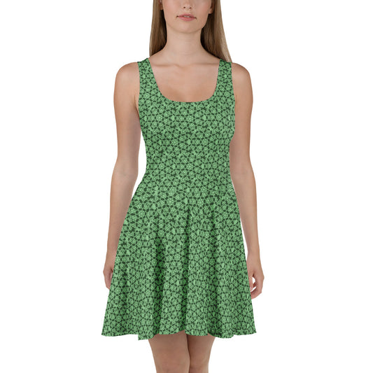 Front shot of a model wearing the skater dress with the 'Heptagon' green fractal geometric pattern.