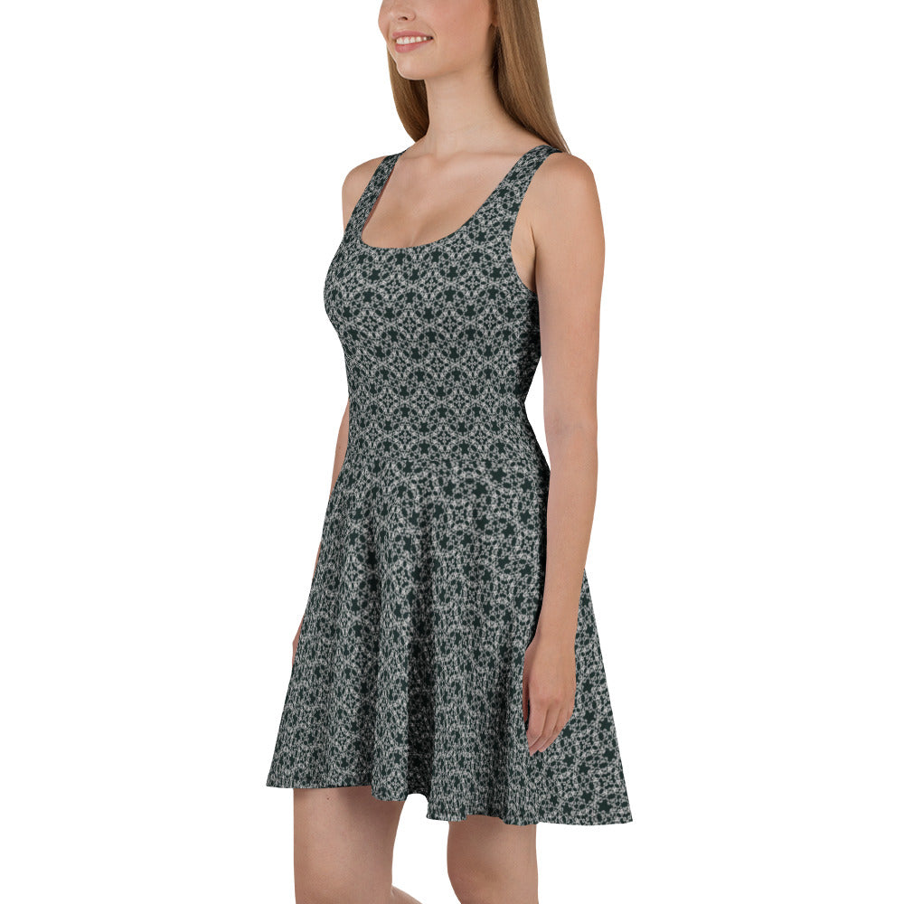 Left angle shot of a model wearing the skater dress with the 'Quadragon' charcoal and white fractal geometric pattern.