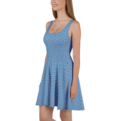 Right angle shot of a model wearing the skater dress with the 'Pentagon' blue and yellow fractal geometric pattern.