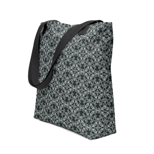 Angle shot of the tote bag with the 'Quadragon' charcoal and white fractal geometric pattern.