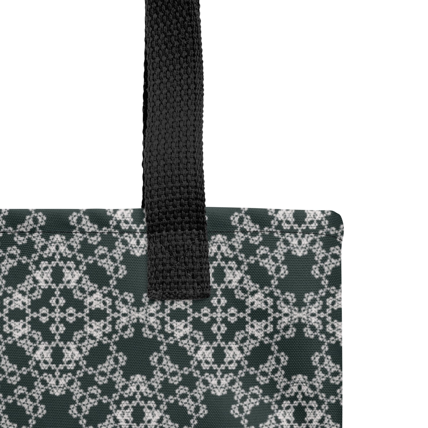 Close up of the strap stitching of the tote bag with the 'Quadragon' charcoal and white fractal geometric pattern.