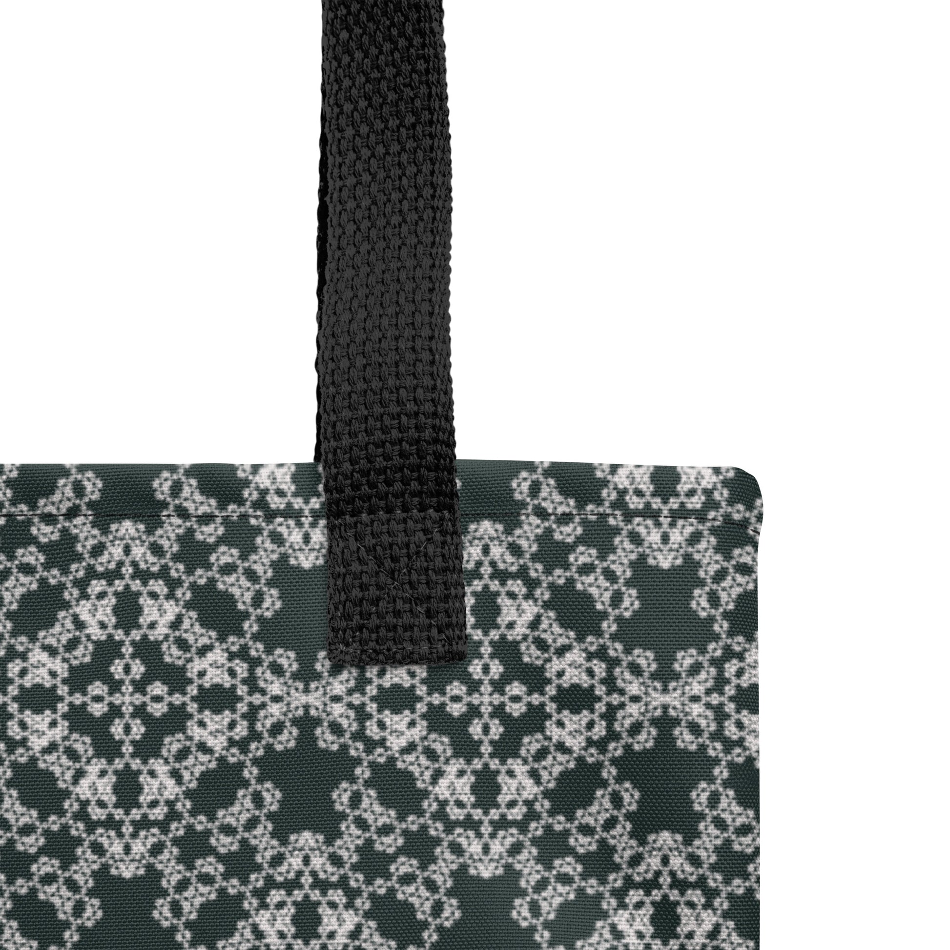Close up of the strap stitching of the tote bag with the 'Quadragon' charcoal and white fractal geometric pattern.