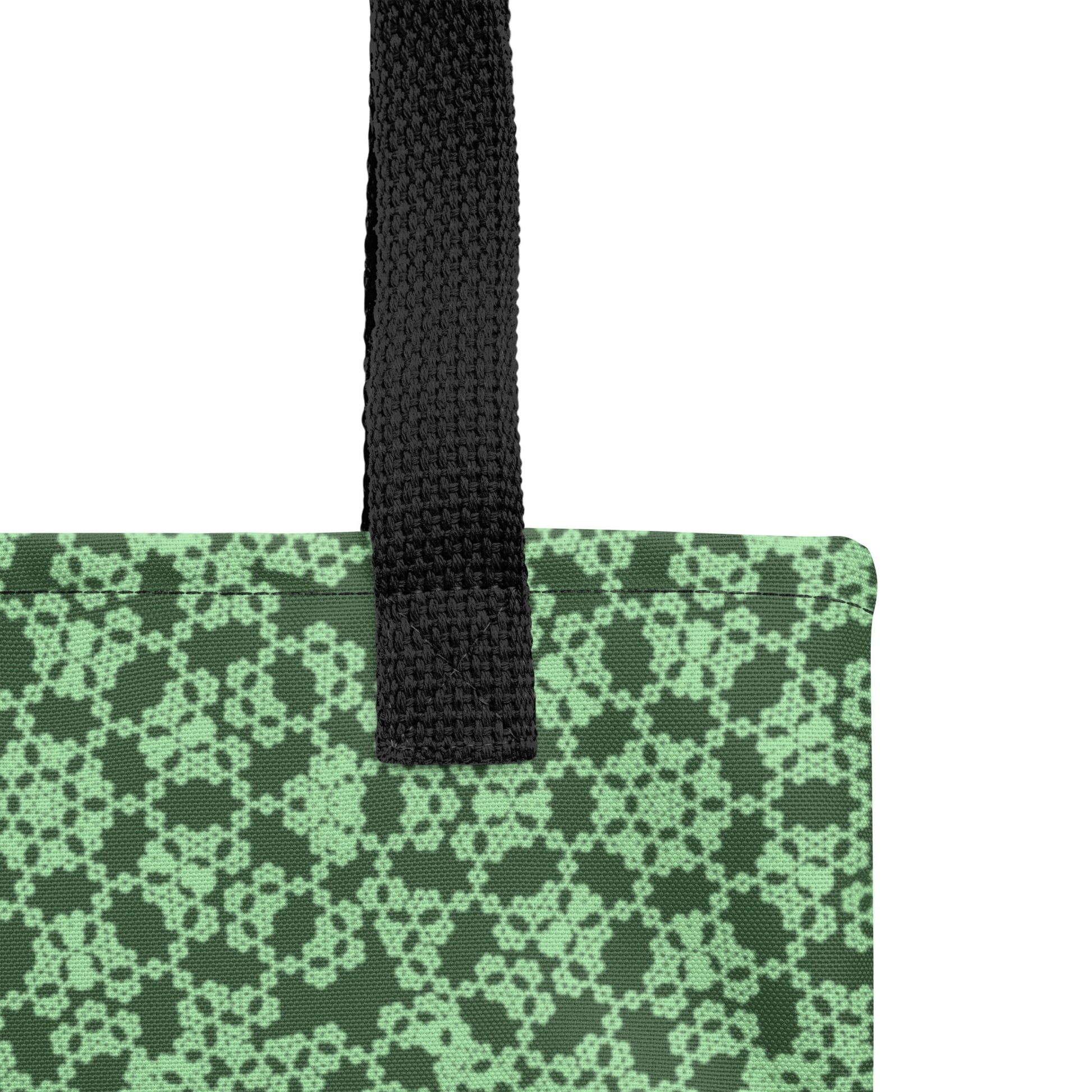 Close up of the strap stitching of the tote bag with the 'Heptagon' green fractal geometric pattern.