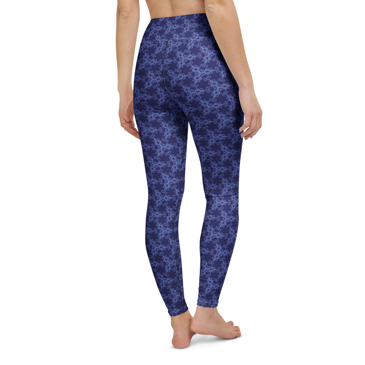 Back close-up of the lower legs of a model wearing leggings with the 'Triagon' navy and blue fractal geometric pattern.