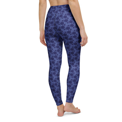 Back close-up of the lower legs of a model wearing leggings with the 'Triagon' navy and blue fractal geometric pattern.