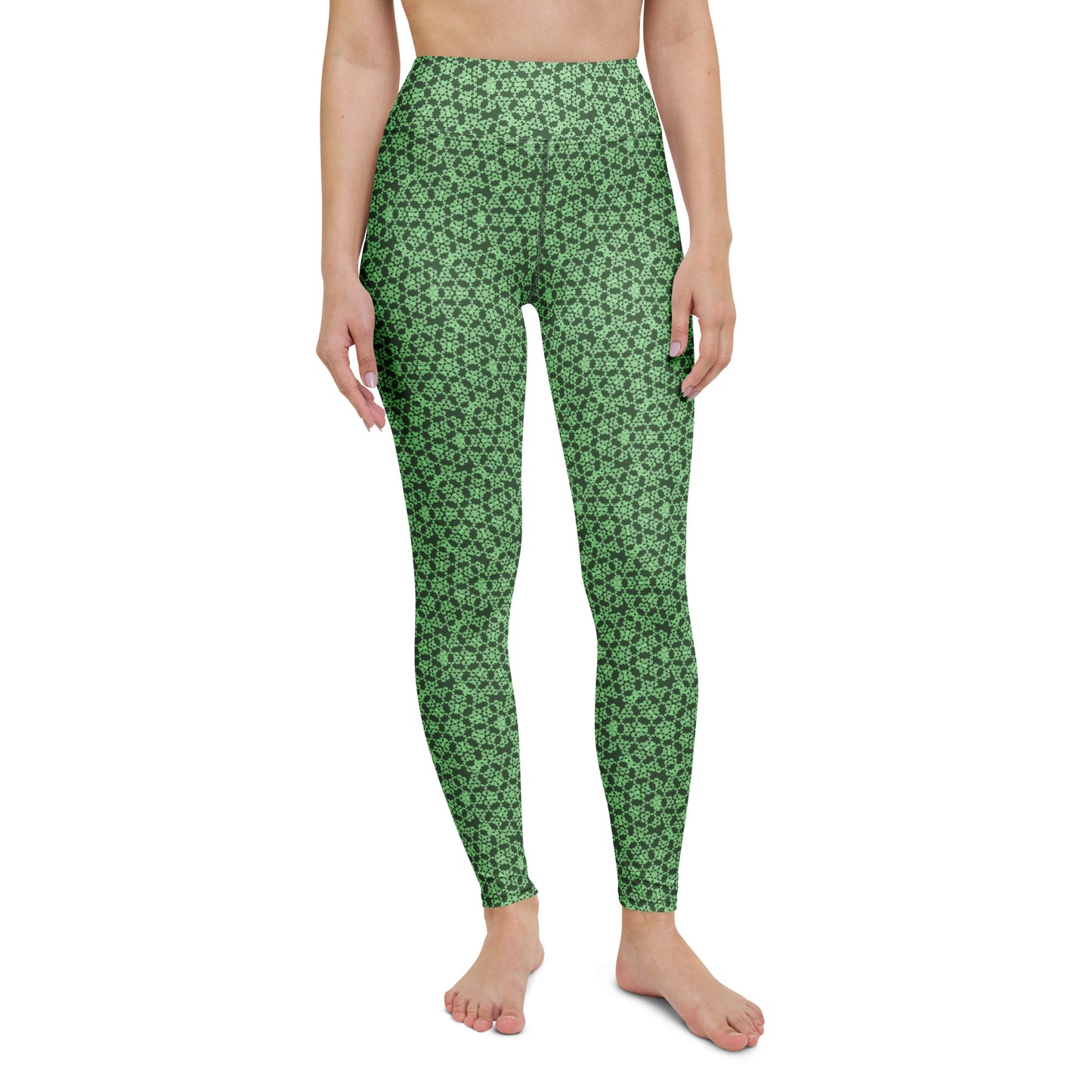 Front close-up of the legs of a model wearing leggings with the 'Heptagon' green fractal geometric pattern.