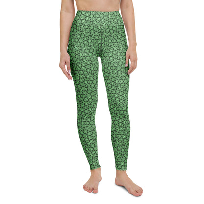 Front close-up of the legs of a model wearing leggings with the 'Heptagon' green fractal geometric pattern.