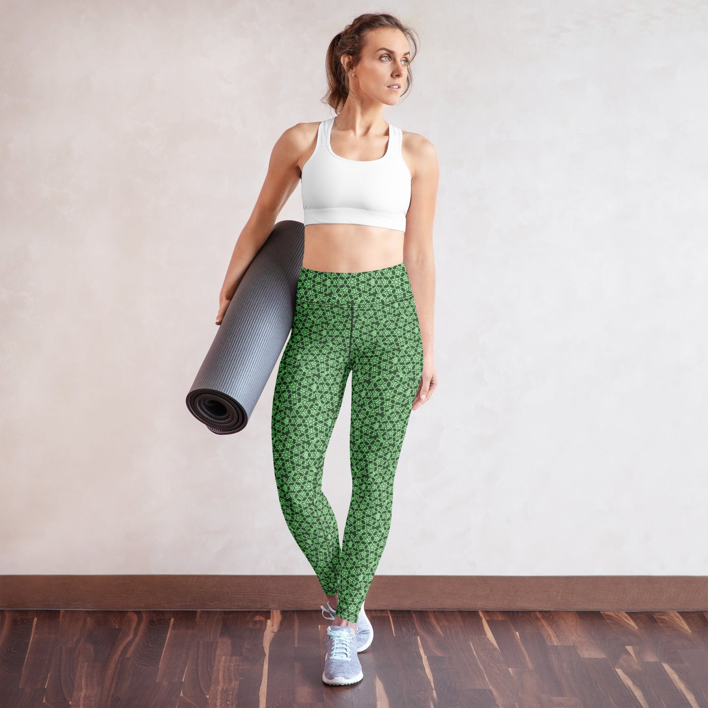 Young woman wearing leggings with the 'Heptagon' green fractal geometric pattern.