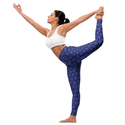 Young woman in a yoga pose wearing leggings with the 'Triagon' navy and blue fractal geometric pattern.