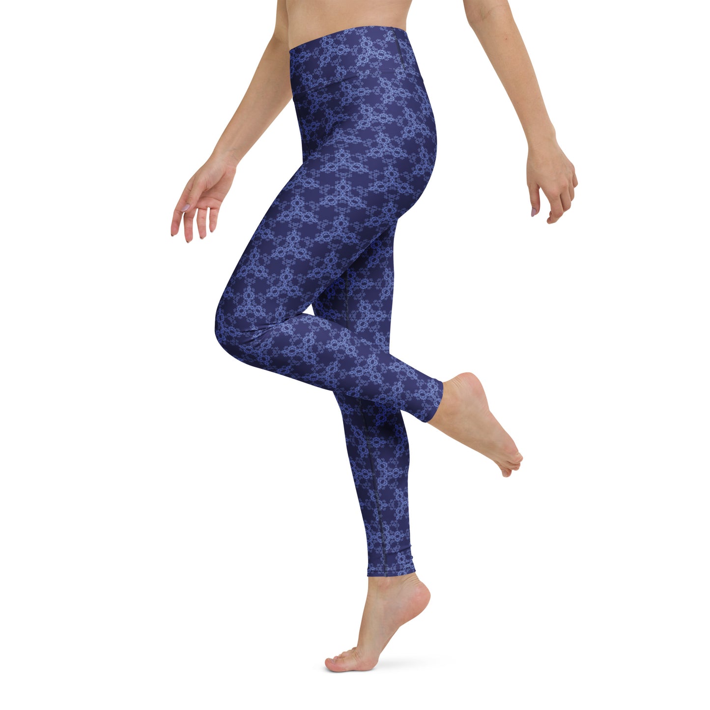 Left close-up of the lower legs of a model wearing leggings with the 'Triagon' navy and blue fractal geometric pattern.