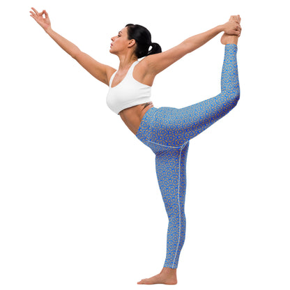 Young woman in a yoga pose wearing leggings with the 'Pentagon' blue and yellow fractal geometric pattern.