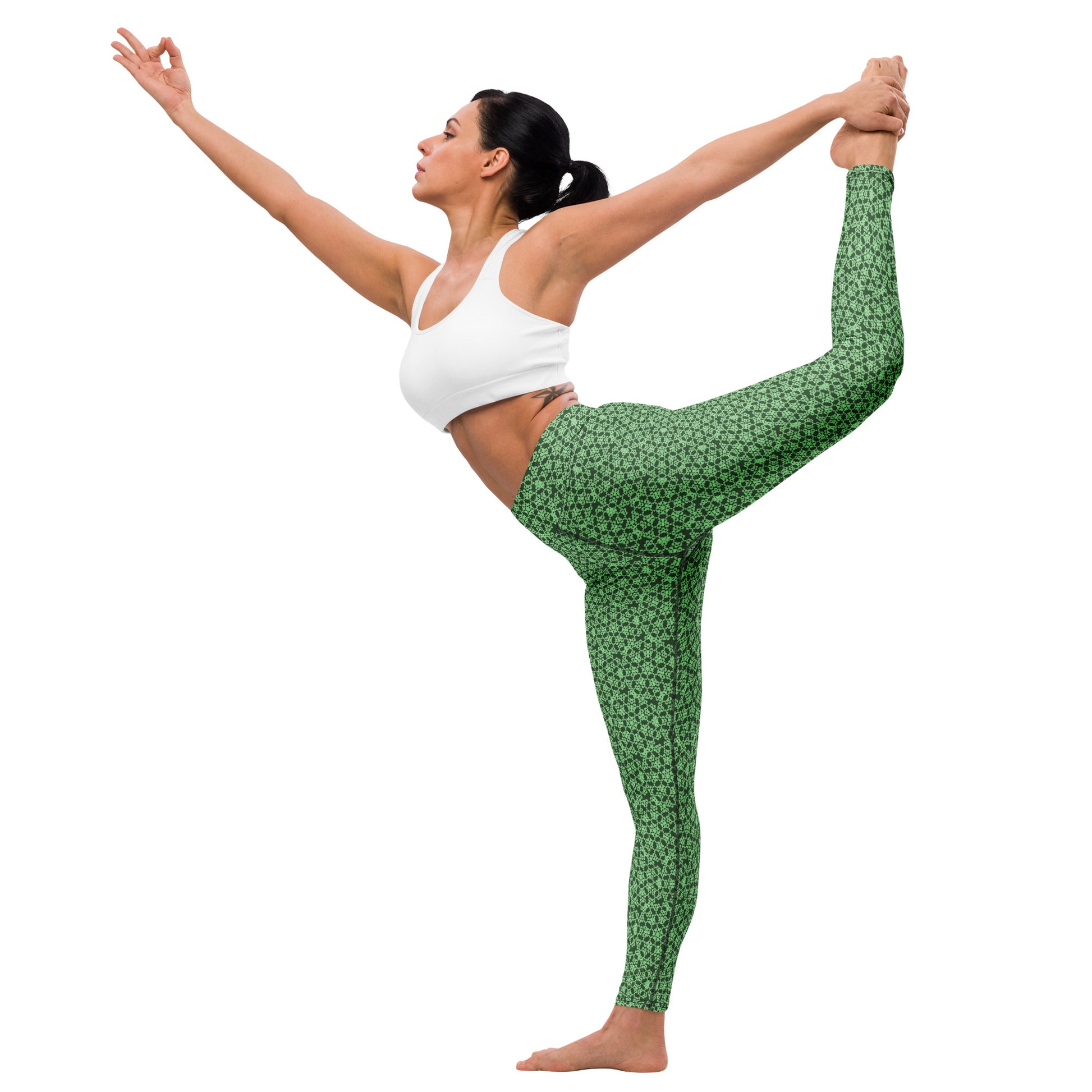 Young woman in a yoga pose wearing leggings with the 'Heptagon' green fractal geometric pattern.