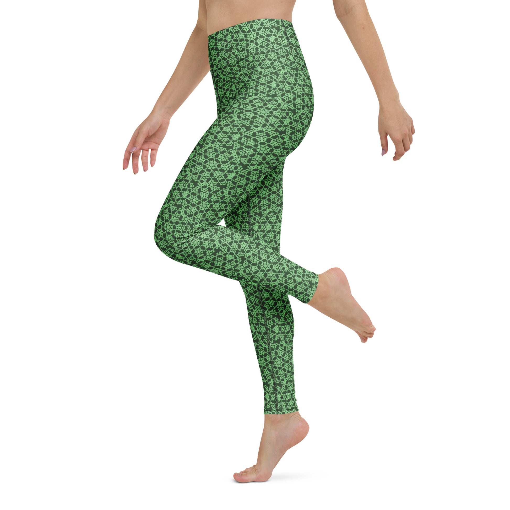 Left close-up of the legs of a model wearing leggings with the 'Heptagon' green fractal geometric pattern.