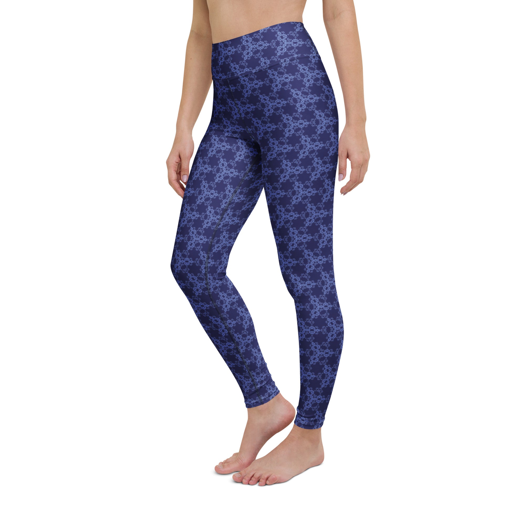 Left-front close-up of the lower legs of a model wearing leggings with the 'Triagon' navy and blue fractal geometric pattern.