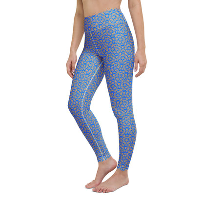 Left-front close-up of the legs of a model wearing leggings with the 'Pentagon' blue and yellow fractal geometric pattern.