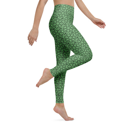 Right close-up of the legs of a model wearing leggings with the 'Heptagon' green fractal geometric pattern.