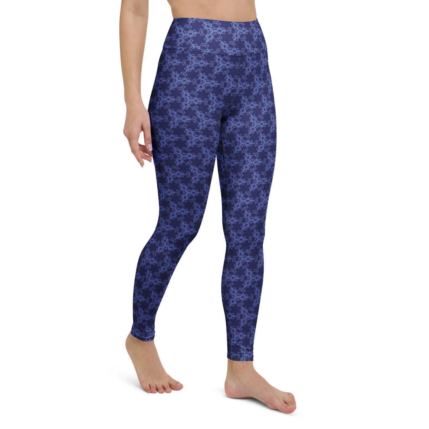 Right-front close-up of the lower legs of a model wearing leggings with the 'Triagon' navy and blue fractal geometric pattern.