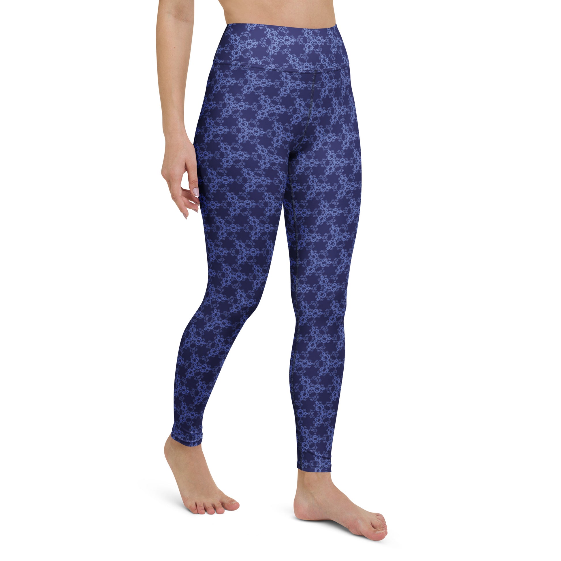 Right-front close-up of the lower legs of a model wearing leggings with the 'Triagon' navy and blue fractal geometric pattern.