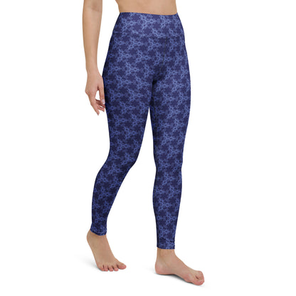 Right-front close-up of the lower legs of a model wearing leggings with the 'Triagon' navy and blue fractal geometric pattern.