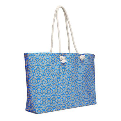 Left angle shot of the oversized weekender bag with the 'Pentagon' blue and yellow fractal geometric pattern.